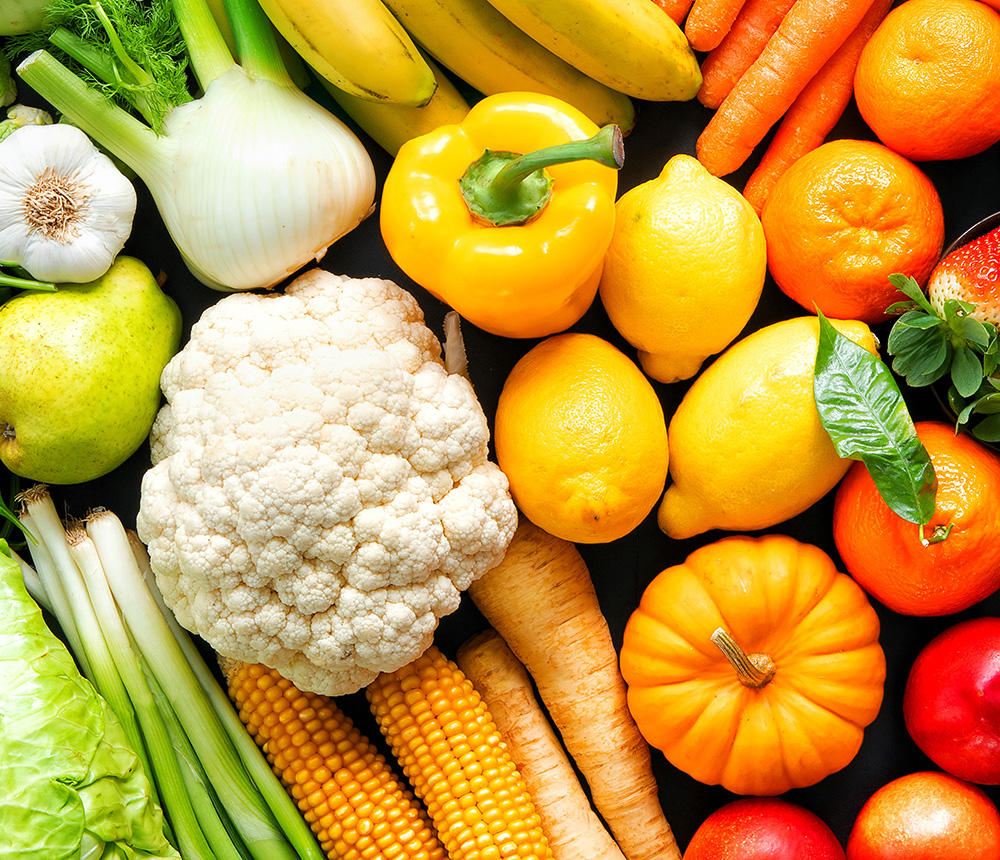 Panoramic food background with assortment of fresh organic fruits and vegetables in rainbow colors - support local