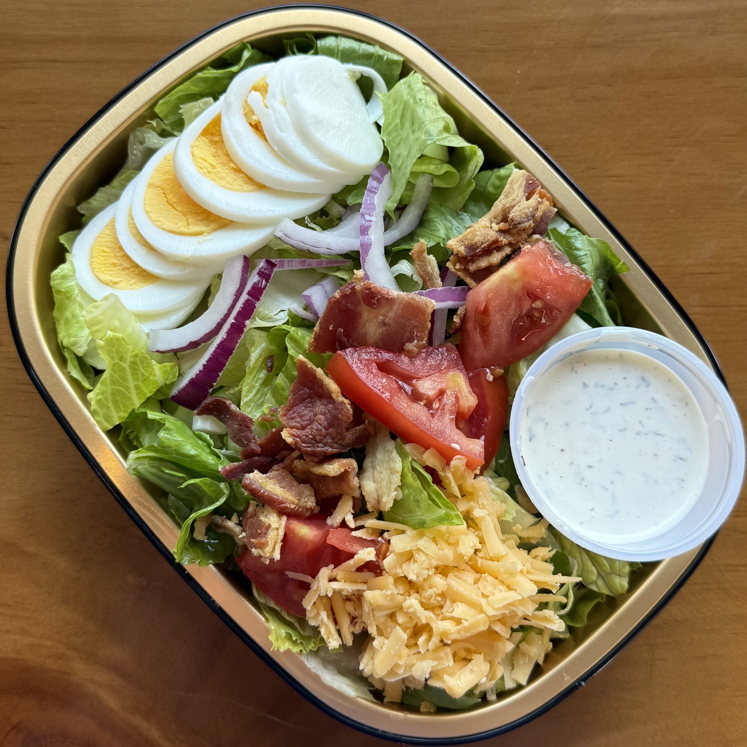 salad with tomato, onion, cheddar, bacon, egg and ranch