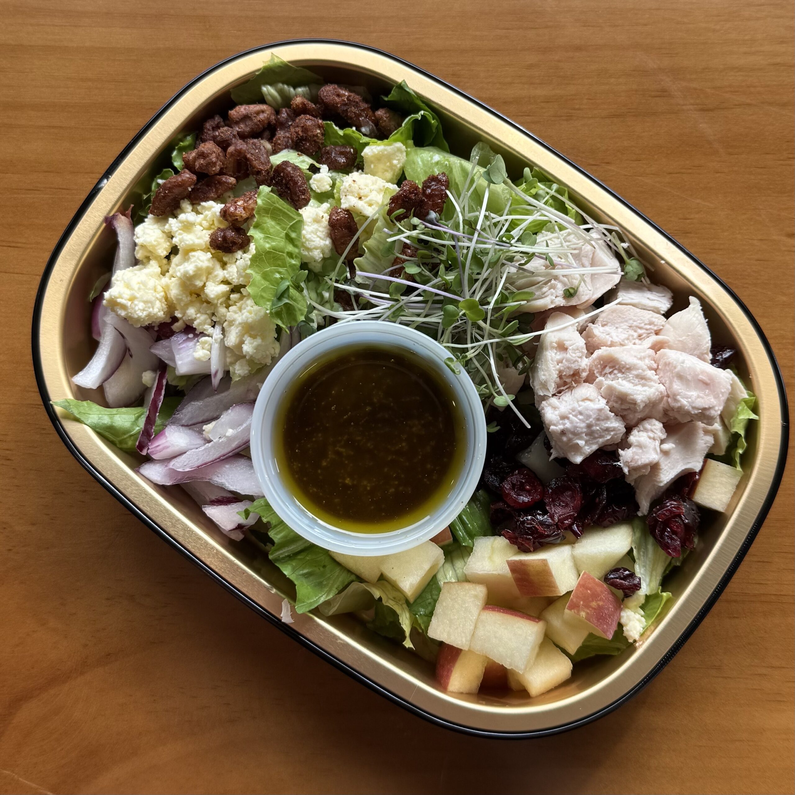 salad with chicken, pecans, apples, cranberries and feta