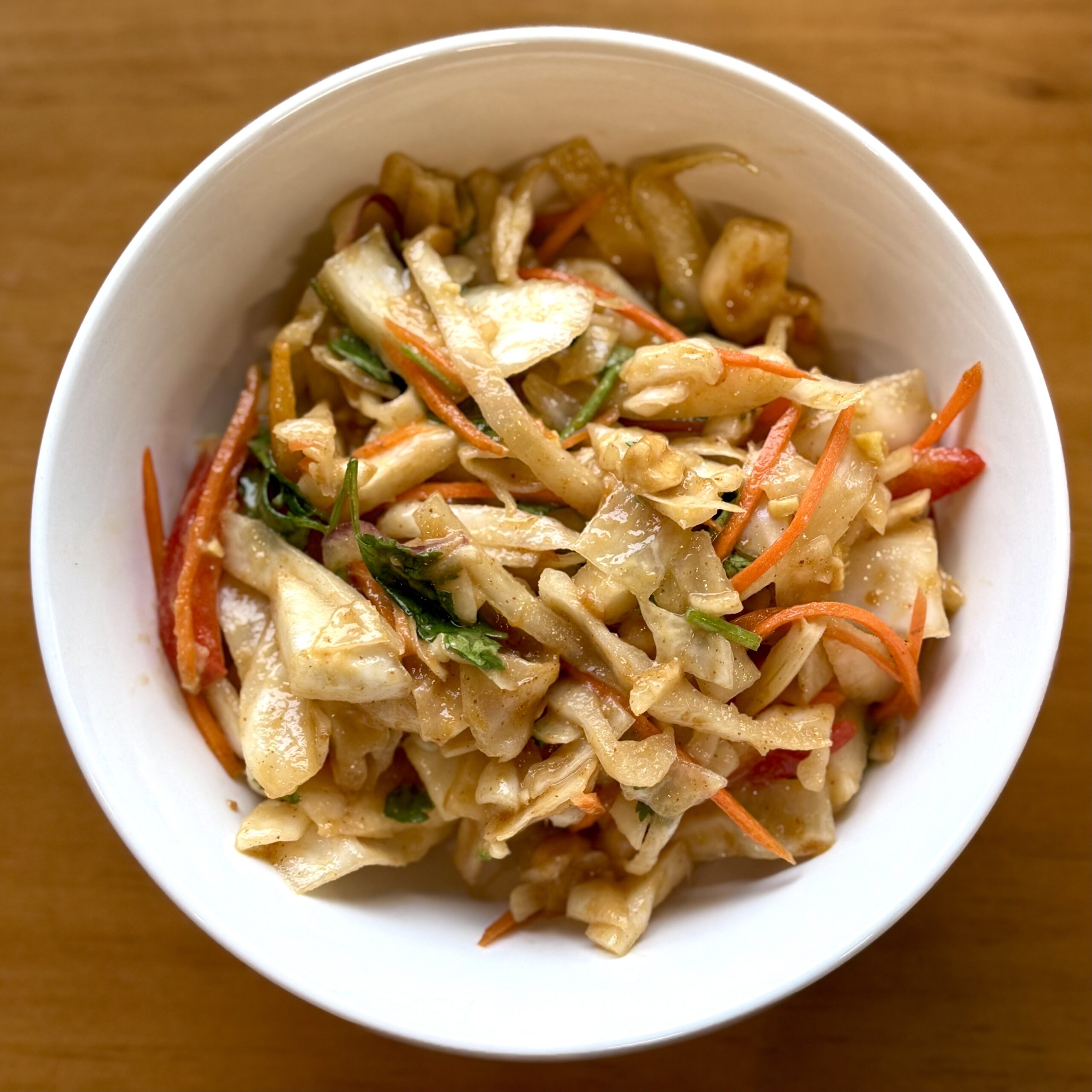cabbage slaw with carrots, peppers, peanuts and asian dressing
