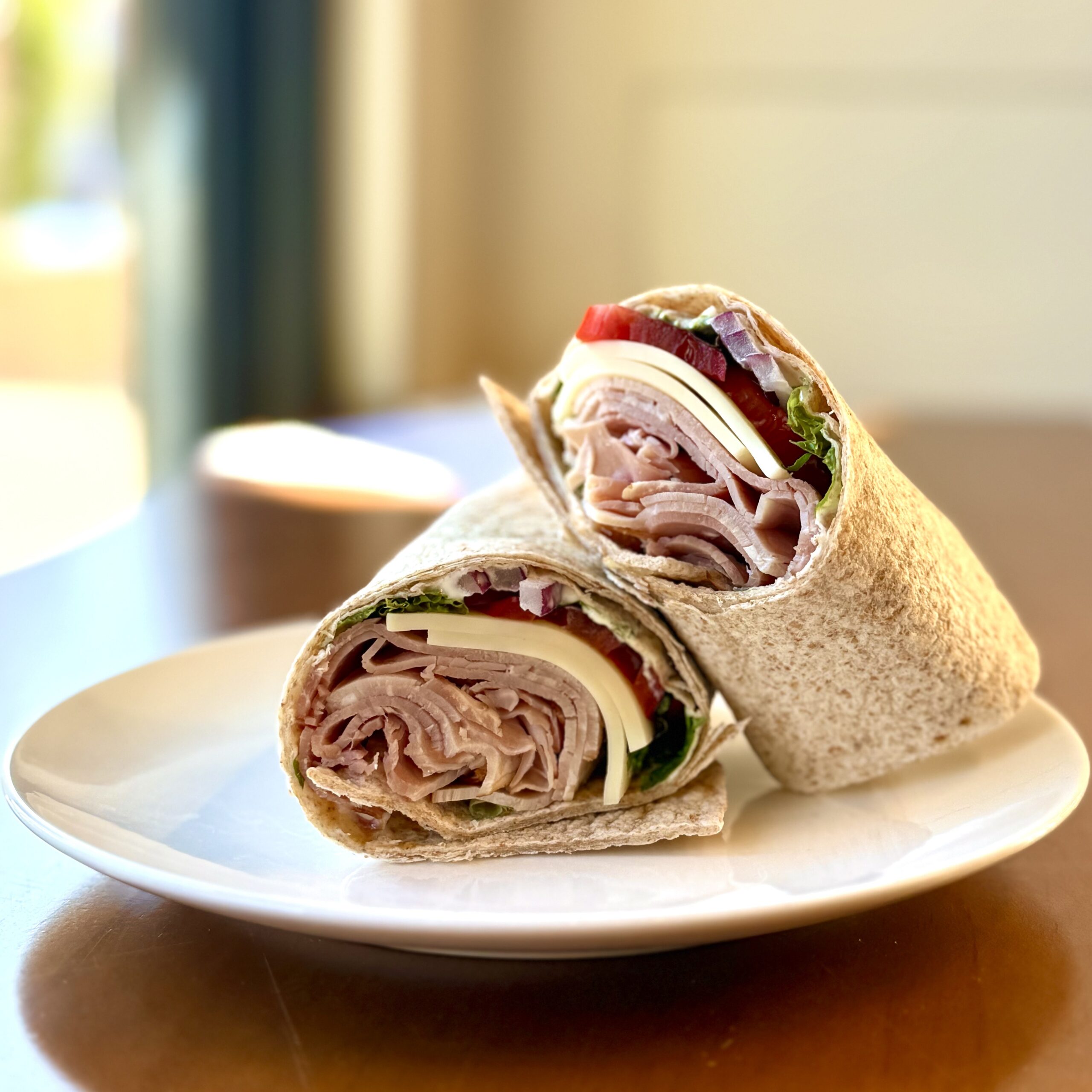 ham and swiss wrap with lettuce, tomato and red onions