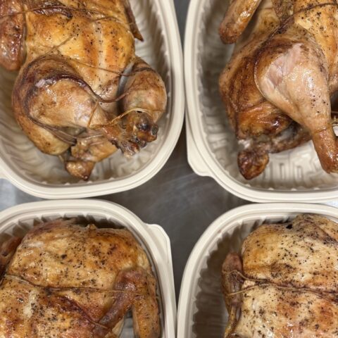 whole rotisserie chicken in a to-go container