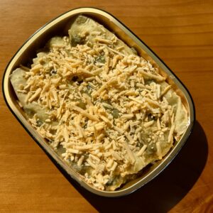 chicken enchiladas with green sauce and cheddar cheese