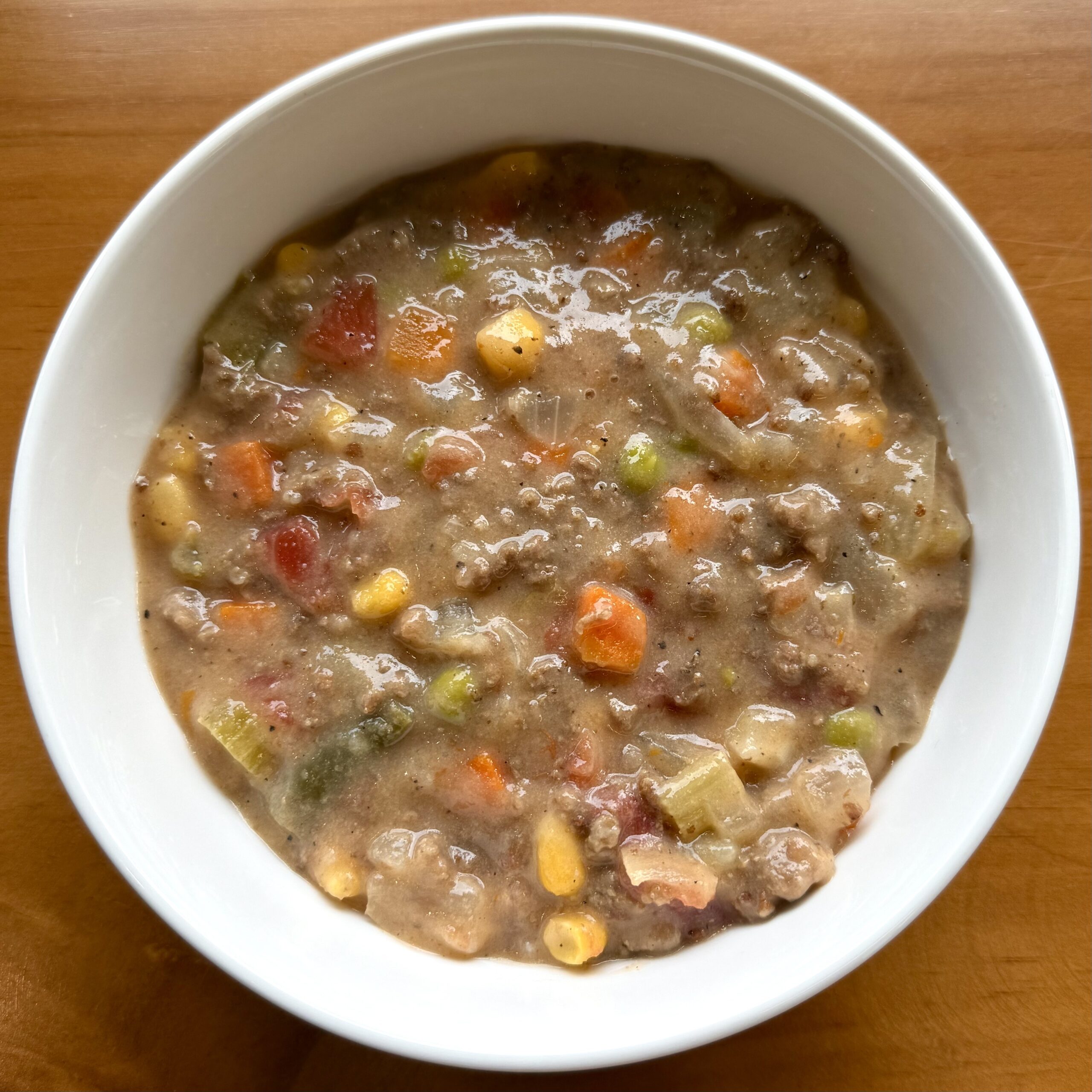 beef stew with carrots, corn, celery and peas