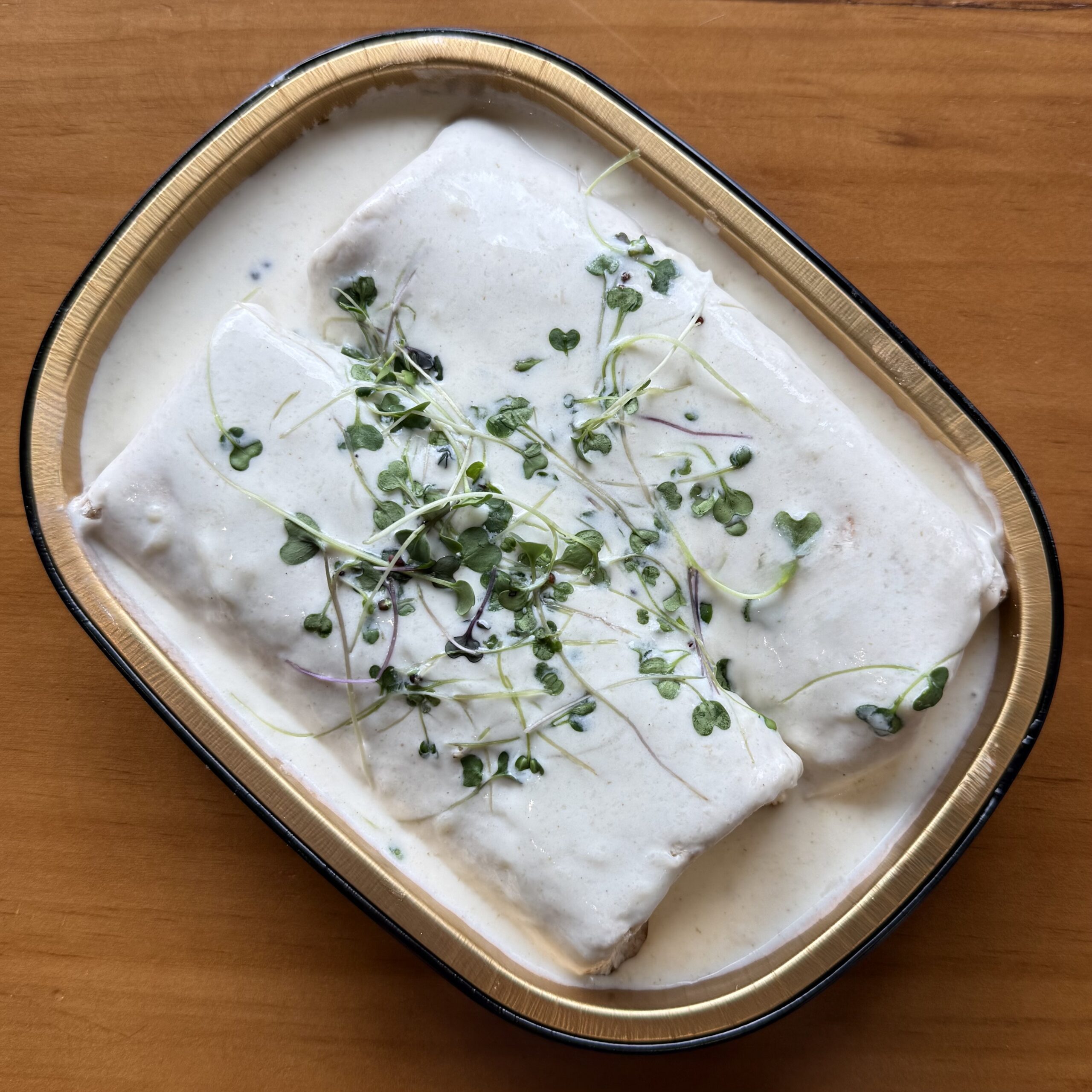 chicken enchiladas in a white cheese sauce