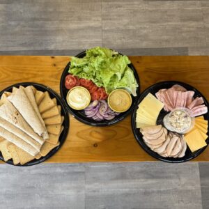 sandwich buffet with meat, cheese, vegetables, bread and tortillas