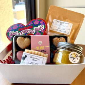 gift basket with chocolate, macarons, soap, candle, bath soak