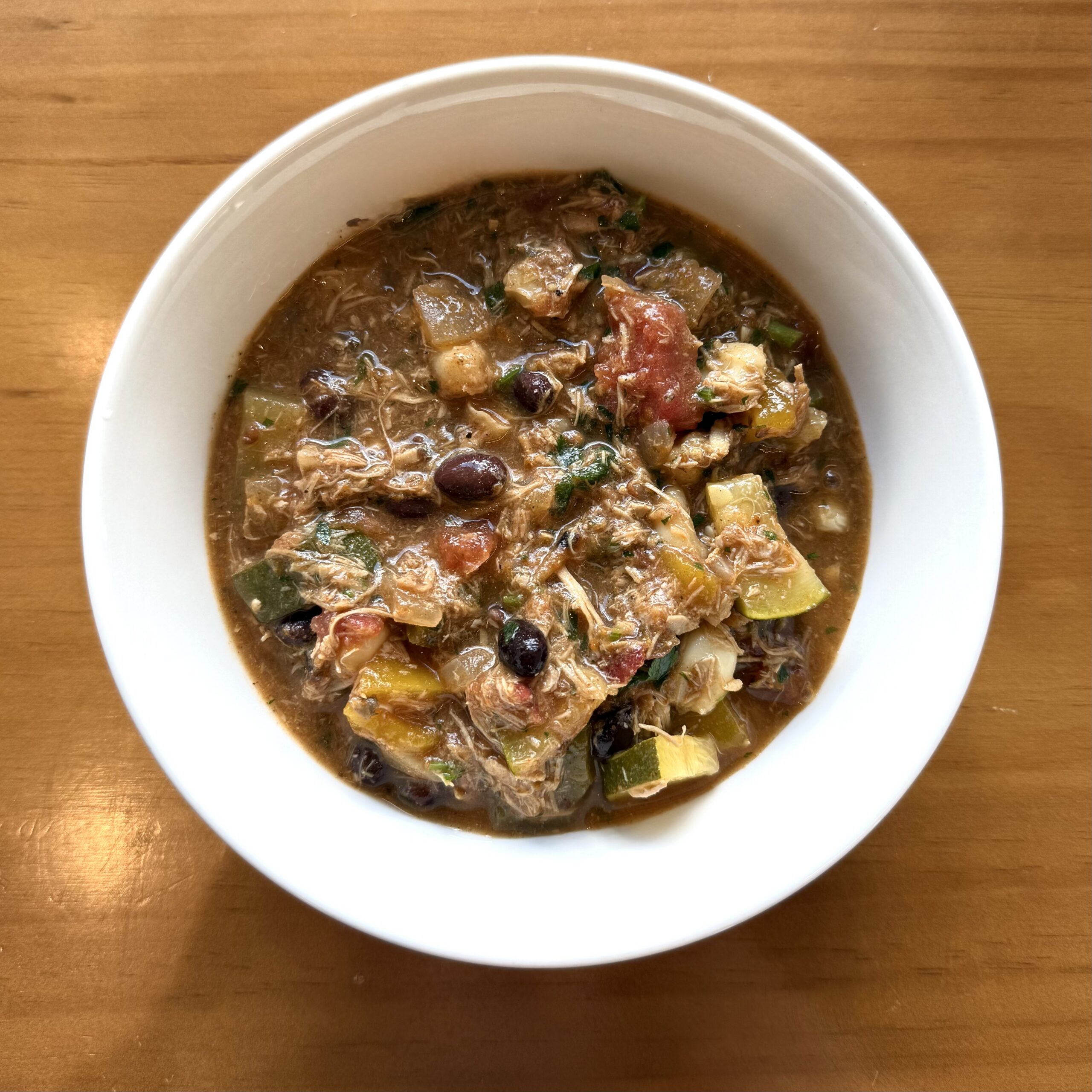 soup with chicken, veggies, beans and cilantro